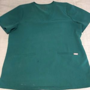 FIGS Women’s 3-Pocket scrub top in Hunter Green.
